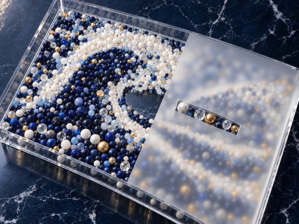 Individual beads are visible beneath clear glass, while a frosted panel obscures most of their details.